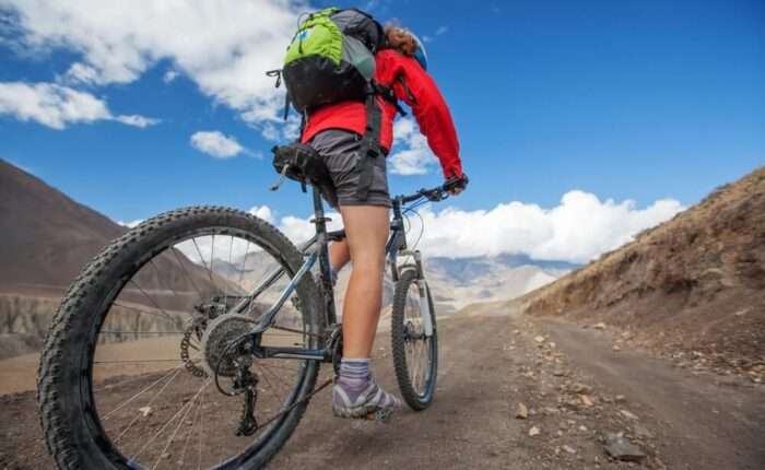 Jomsom Muktinath Mountain Bike Tour girl-cycling-road-himalaya